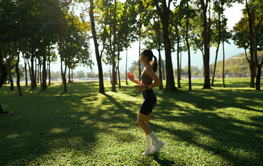Woman jogging in park enjoying healthy outdoor lifestyle