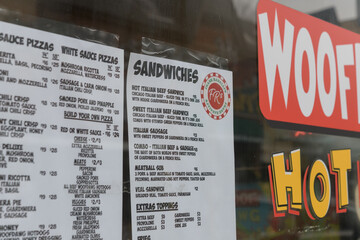 Fototapeta premium menu inside window at Frank Ranalli's Pizza and Italian Beef, a pizza restaurant, located at 185 Baldwin St, Toronto