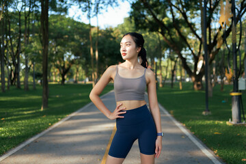 Asian woman taking a break from exercising in park