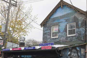Fototapeta premium exterior building facade and sign of Kensington Kitchen, a takeout restaurant, located at 255 Augusta Av, Toronto