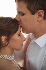 Young newlyweds sharing a romantic kiss, close up