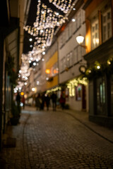 Cinematic narrow street under glowing lanterns, romantic evening scene along ancient cobblestone pathway