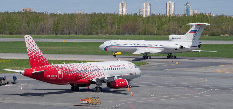 SAINT PETERSBURG, RUSSIA - MAY 20, 2022: Russian Sukhoi SuperJet 100-95B Maikop (RA-89174) and Soviet Tu-154B-2 (RA-85605) on the airfield of Pulkovo Airport on a sunny May day