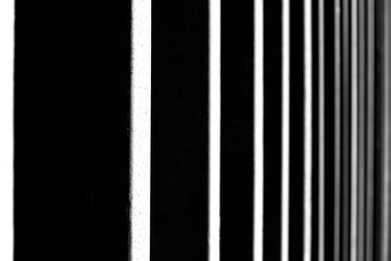 Close-up photograph of black and white abstract of strong vertical lines or stripe. The contrast and perspective create a sense of depth and geometric pattern, Pitkäsilta, Helsinki, Finland.