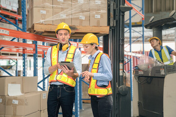 Caucasian man, woman warehouse supervisor discuss and use tablet check package with forklift driver worker load box on shelf, product distribution inventory management,Logistics shipping business plan