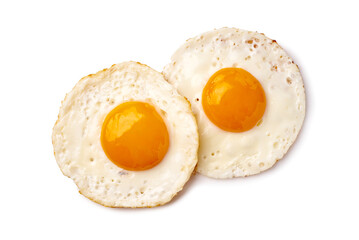 Minimalistic presentation of fried eggs showcasing vibrant yolks and delicate crispy edges