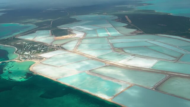 Drone view of salt farms and crystallization pools showing traditional sea salt production process