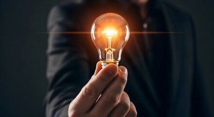 Brilliant idea man holds glowing lightbulb, sparking innovation and creative solutions for business success, modern thinking