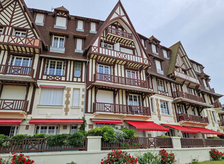 Trouville-sur-Mer, Normandy, France - May 31, 2025: Neo-Norman architecture of Trouville town. The facade is characterized by dark half-timbered beams over white stucco. Coastal resort building