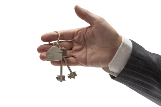 Concept of selling or renting a car. Hand of man in formal suit holding car keys on isolated background