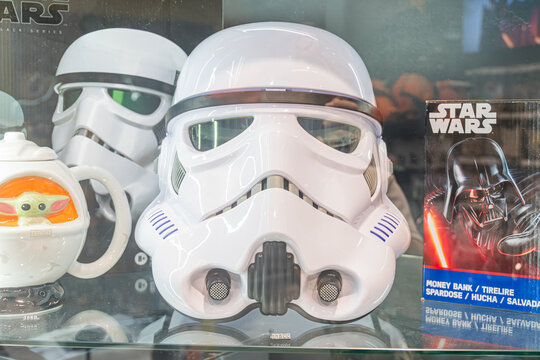 A collection of Star Wars memorabilia on shelves, centered around a large white Darth Vader helmet with black visor and neck ring Nearby are a colorful figurine and - Kyiv, Ukraine 07-06-2025
