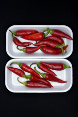 Red capsicum on a plastic backing. Red pepper pods.
