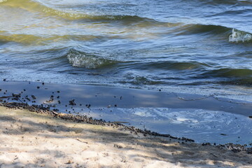 The surface of the water with waves and foam, close-up