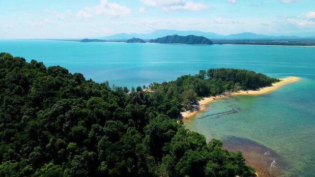 Aerial view of Pantai Bukit Keluang, Besut, Terengganu, showing turquoise waters, coastal cliffs, and clear sunny skies along the scenic shoreline.