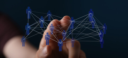 Hand interacting with digital network of interconnected people symbolizing teamwork, unity, and global communic