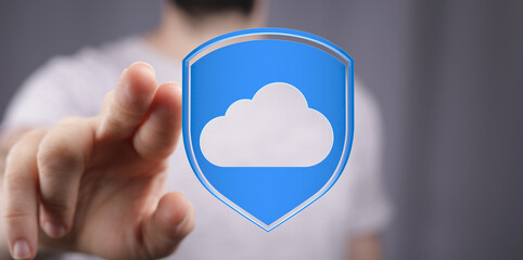Hand pointing towards cloud computing symbol representing secure data storage and protection. Modern technology