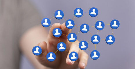 Hand touching network of people icons, representing social connections and digital communication.