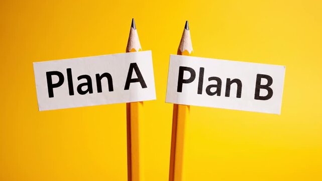 Two pencils with signs for plan a and plan b moving closer and farther apart on a bright yellow background, representing the difficulty of making a decision and the fear of a better option