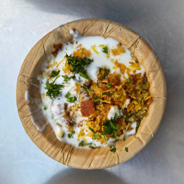 Aloo tikki (Chaat Dish) with curd. It's an Indian Cuisine made with potato and with variety of chutney (sauces). It has lots of spices masala in it. 