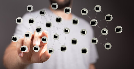 Conceptual image of a man's hand touching a network of digital files, symbolizing data sharing and technology.