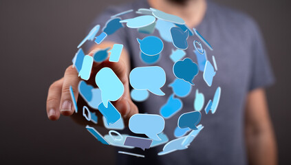 A hand interacts with chat bubbles, symbolizing online communication, social networking and global connections. Ideal for illustrating digital d