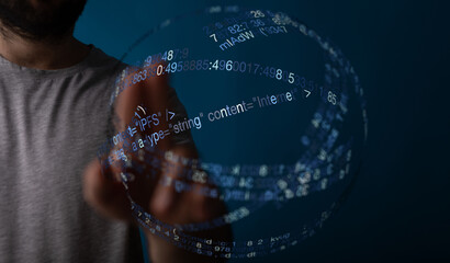 Abstract shot of a hand interacting with digital data streams forming a sphere. Concept of the internet, information technology, and
