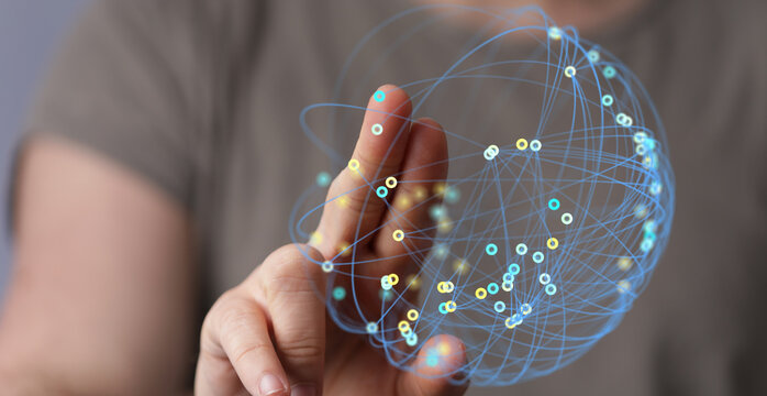 Person's hand touching a digital globe, representing global connection, technology, and data networks. Concept of the future, innovation, commun