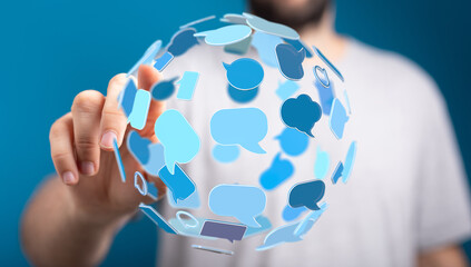 Close up of person's hand interacting with digital sphere of floating blue speech bubbles. Conceptual of global communication network.