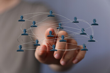 Hand interacting with connected people representing networking, social connections, communication, global reach, and community. Concept for busi