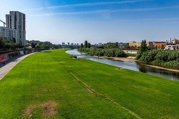 Obraz premium Besòs River Fluvial Park and Santa Coloma Gramanet, Spain. environmental themes, urban planning, green infrastructure, or leisure activities in the Barcelona metropolitan area.