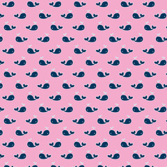 Seamless pink background with cute navy blue whales and water spouts, playful nautical pattern ideal for kids designs, baby shower decor, wrapping paper, fabric prints and ocean-themed projects.