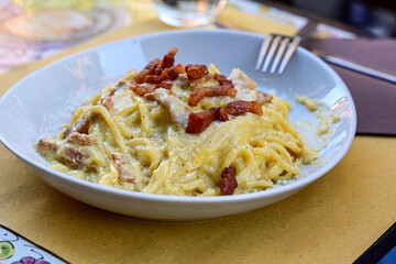 Fresh pasta    tonnarelli alla carbonara and Aperol Spritz  at  typical italian resaturant at Trastevere   neighbourhood at Rome 