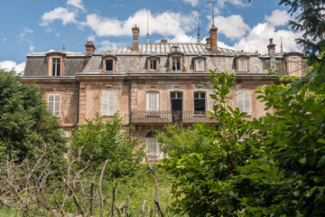 Abandoned French Chateau with Mansard Roof and Overgrown Garden