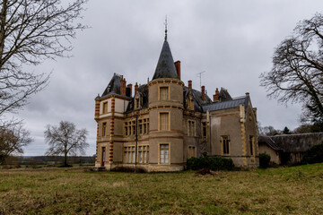 Abandoned French Chateau with Turret and Slate Roof in Moody Overcast Countryside