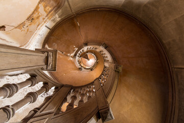Weathered Spiral Wooden Staircase in an Abandoned Historic Interior