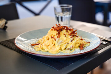 Fresh pasta    tonnarelli alla carbonara and Aperol Spritz  at  typical italian resaturant at...