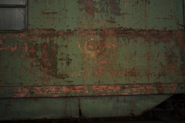 Rusted Deutsche Bundespost Railcar with Peeling Green Paint and Faded Postal Horn Emblem