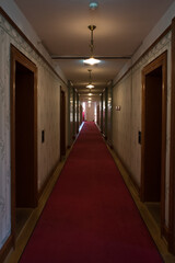 Art Nouveau Hotel Corridor with Red Carpet and Ornate Pendant Lights