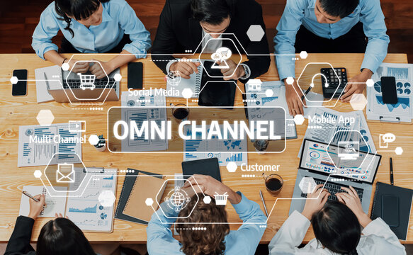 A top-down view of professionals in a meeting exploring omni channel approaches to enhance customer experience with insights from digital marketing and social media trends. Amity