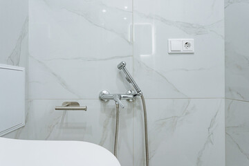 compact modern plumbing, elegant bathroom with chrome fixtures, wallmounted shower system with stylish marble accents, accessible and lowmaintenance sanitary design with sleek surfaces