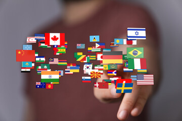 Hand interacting with a collage of international flags representing global connection and unity. Ideal for themes of globalization, travel, and