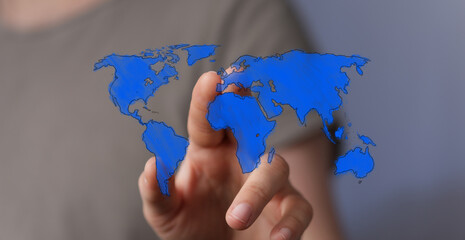 Person pointing finger at blue digital world map, representing global connectivity, future, travel, and technology innovation