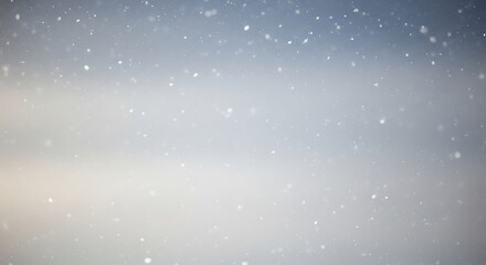 Soft focus winter snowfall gentle falling snowflakes in a muted landscape