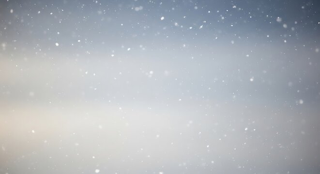 Soft focus winter snowfall gentle falling snowflakes in a muted landscape