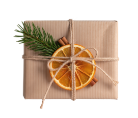 Christmas gift box wrapped in craft paper with dried orange slice, fir twig and cinnamon sticks, isolated on white or transparent background.