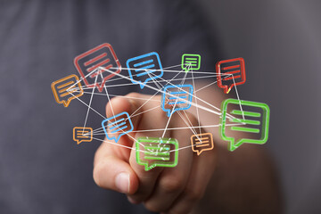 A person's hand interacts with glowing message bubbles. Illustrating communication, connection, social media, online conversations, and digital