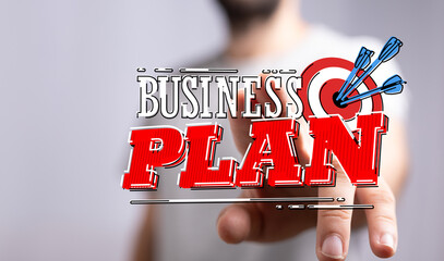 Image of a hand reaching towards a business plan graphic. This visually represents the pursuit of a...