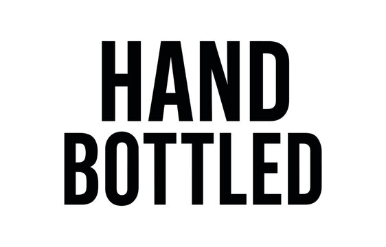 Clean bold typography with text HAND BOTTLED condensed symmetric alignment white background minimal beverage label typography