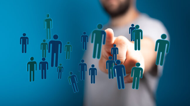 Concept of teamwork and community depicted by a man pointing at floating human figures. Highlighting networking - Powered by Adobe