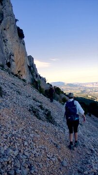 Slow motion, a copule walking on a rocky path in Serrella mountain, Alicante (Spain).